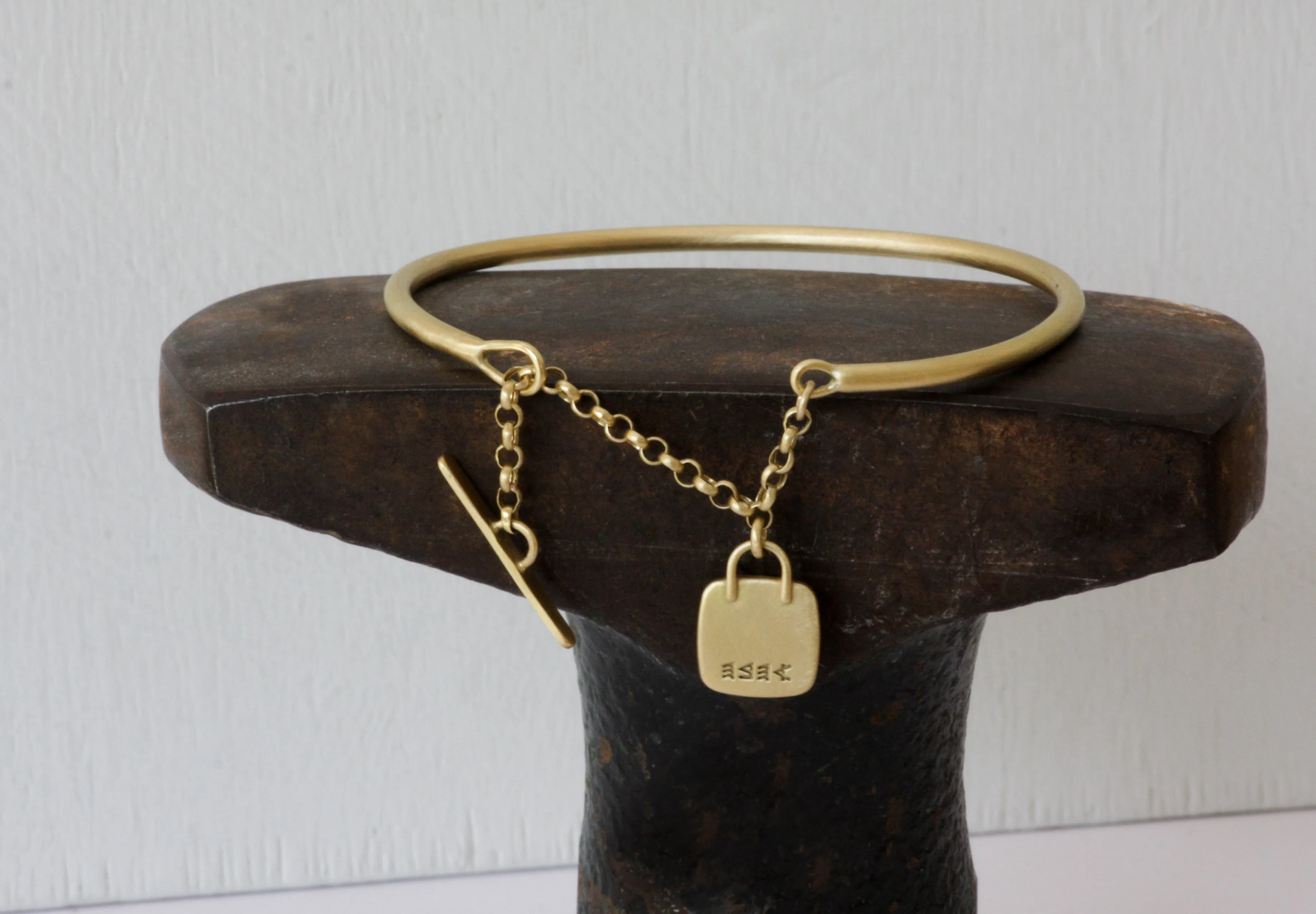 Gold filed Open cuff bracelet with closure chain & charm