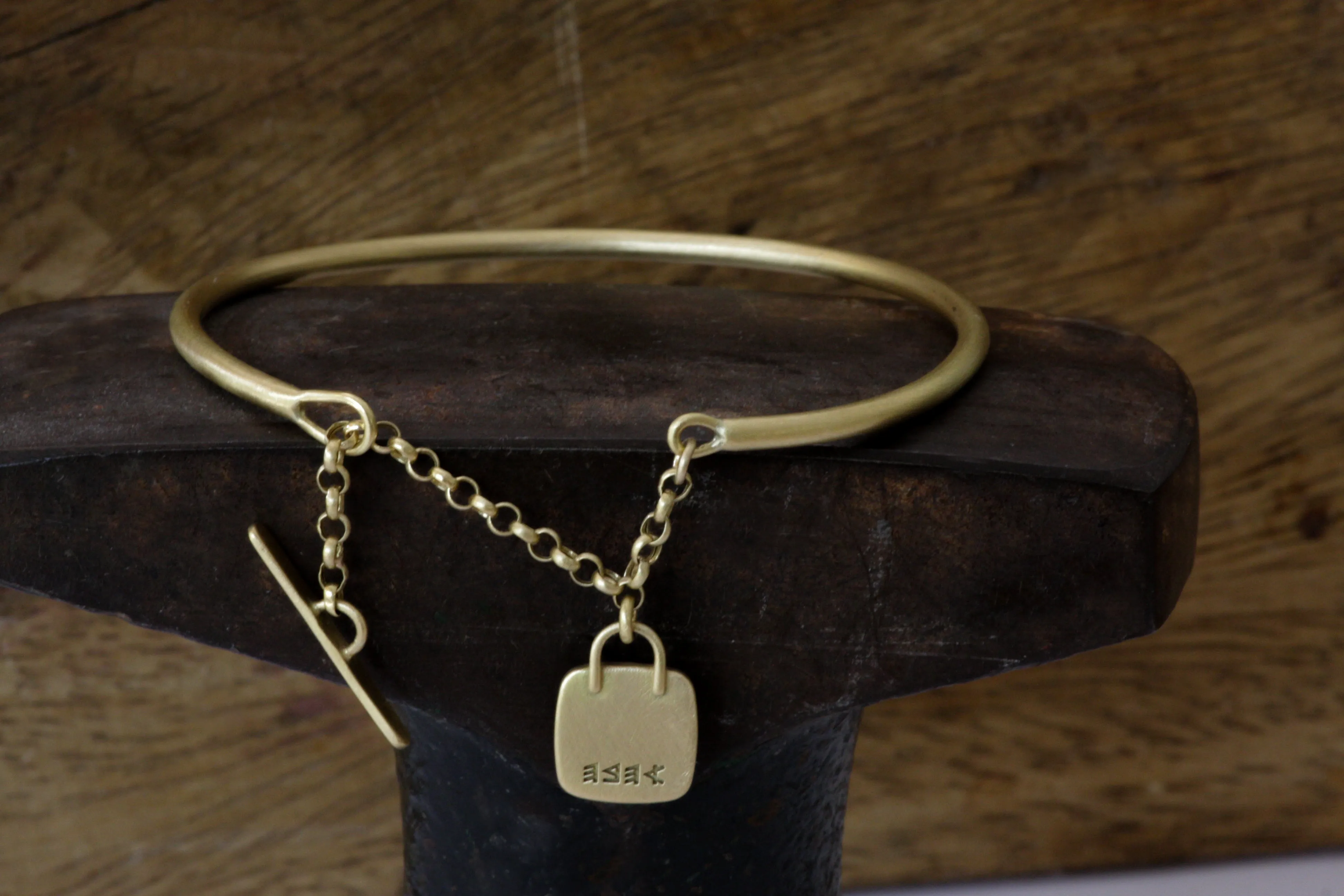 Gold filed Open cuff bracelet with closure chain & charm