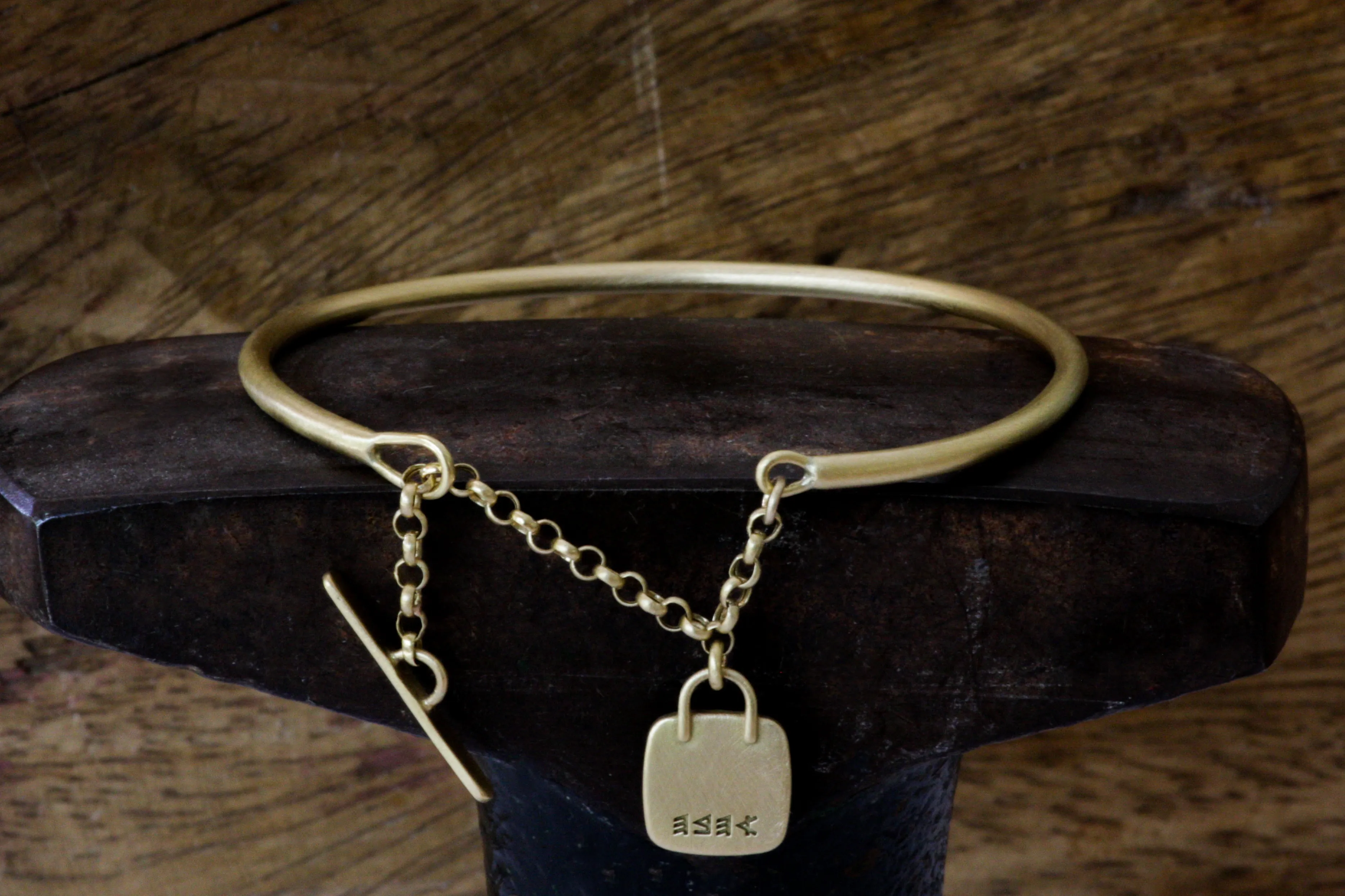 Gold filed Open cuff bracelet with closure chain & charm