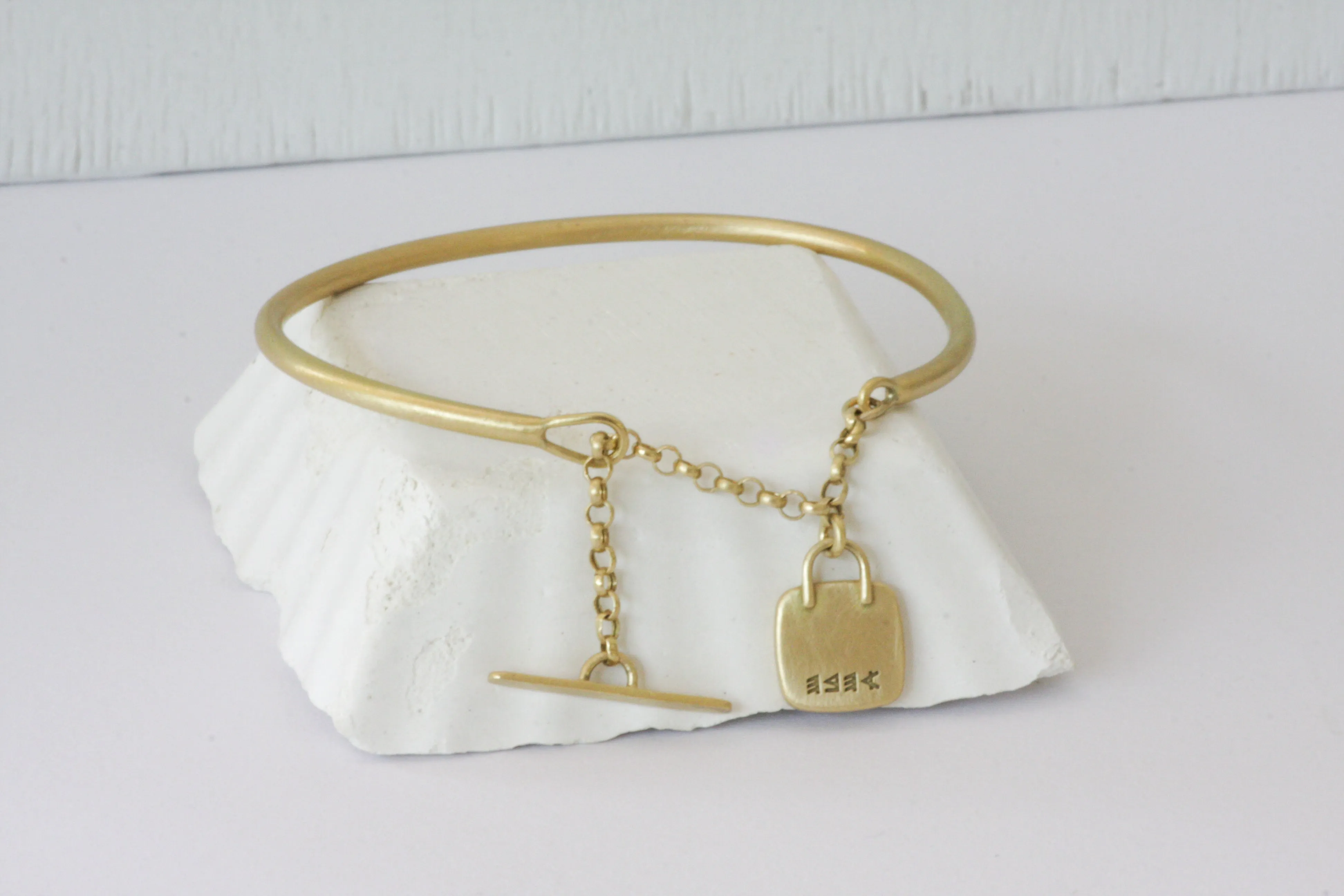 Gold filed Open cuff bracelet with closure chain & charm