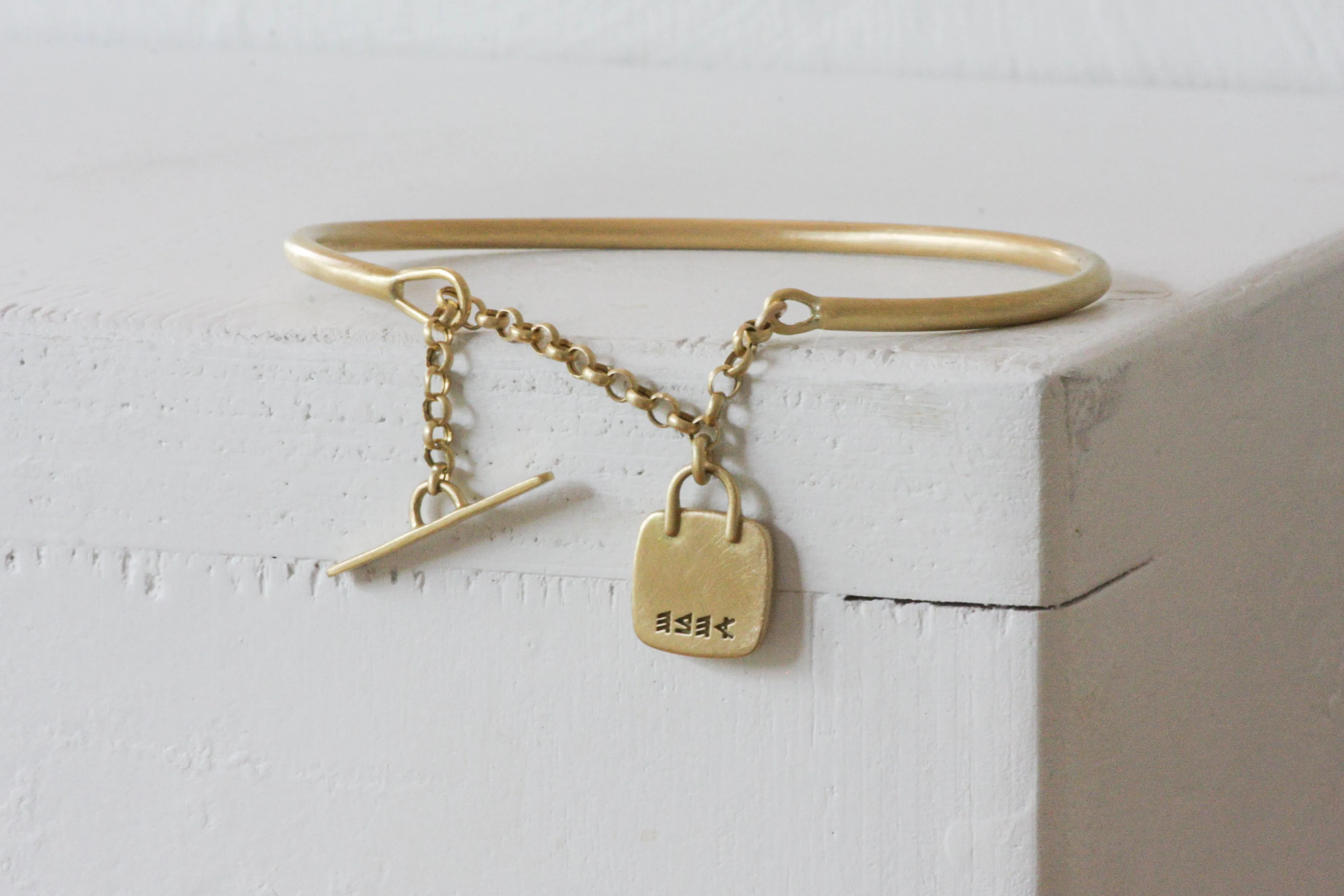 Gold filed Open cuff bracelet with closure chain & charm