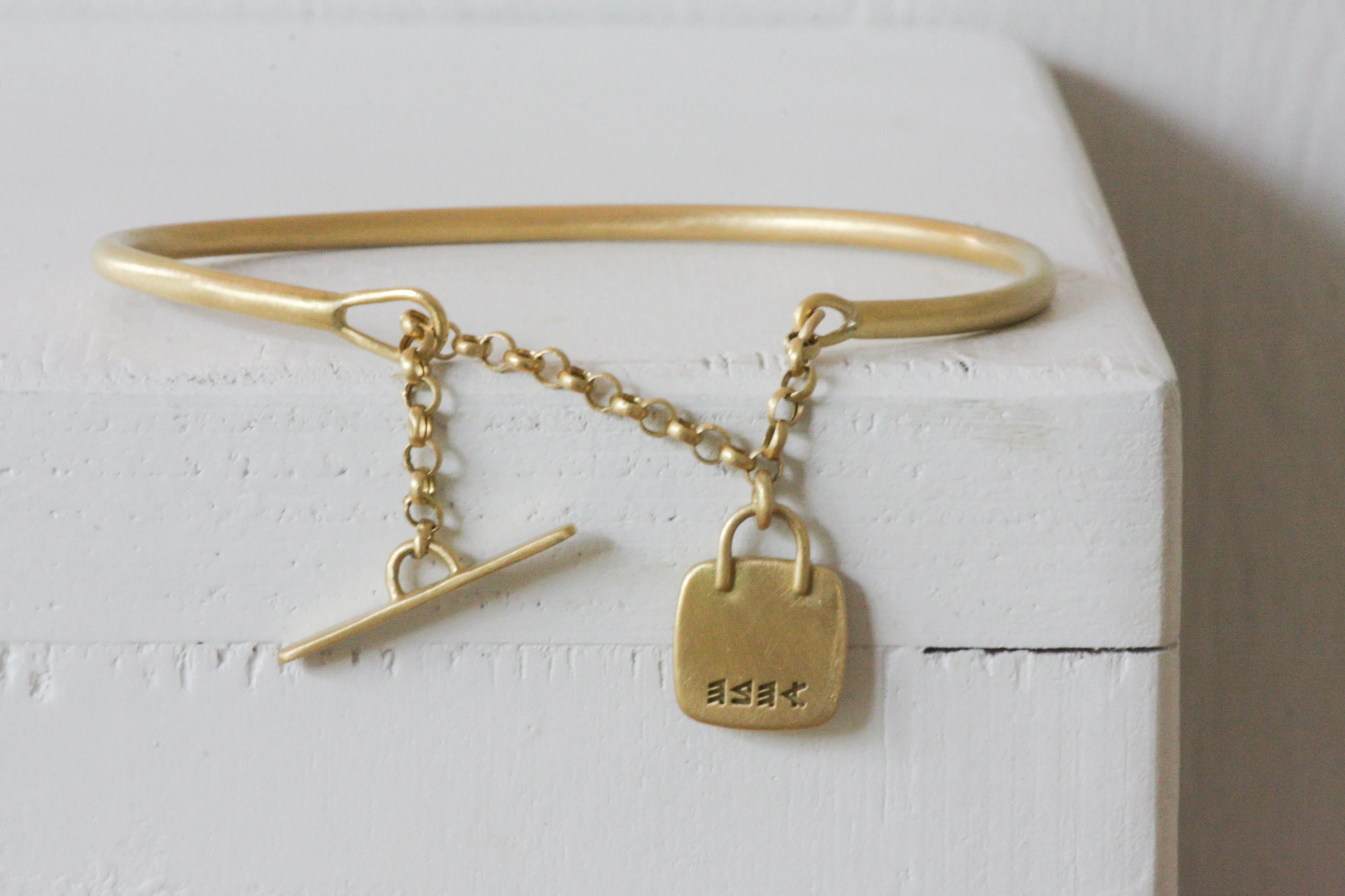 Gold filed Open cuff bracelet with closure chain & charm