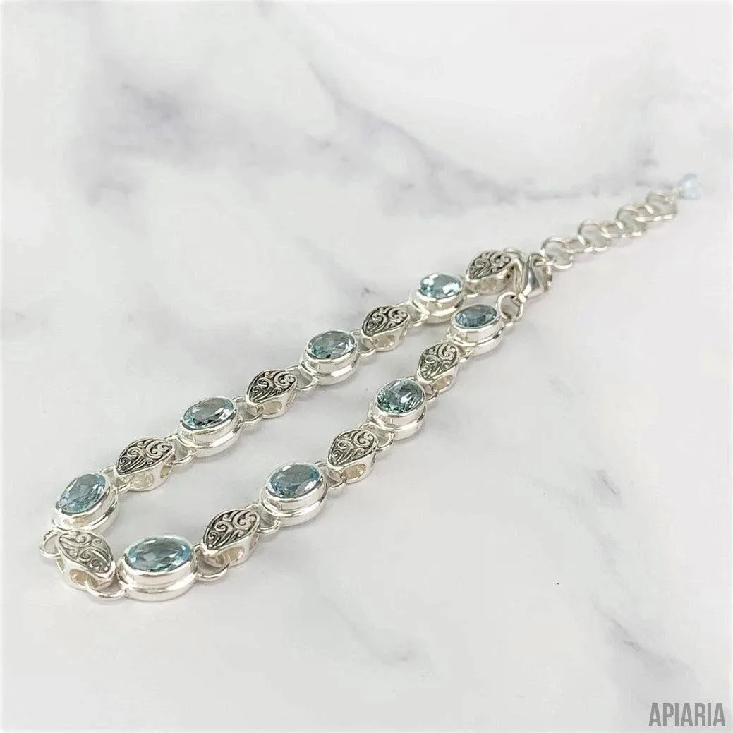 Sterling Silver Bracelet with Faceted Blue Topaz and Carved Link