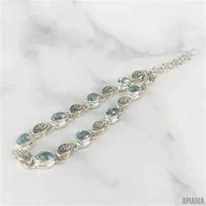 Sterling Silver Bracelet with Faceted Blue Topaz and Carved Link
